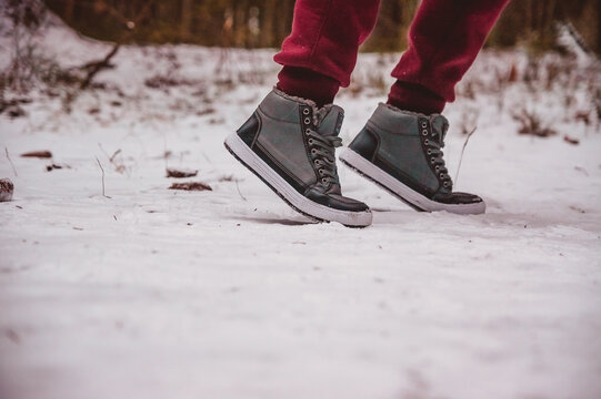 The Legs Of A Person About To Run Along A Snowy Winter Path