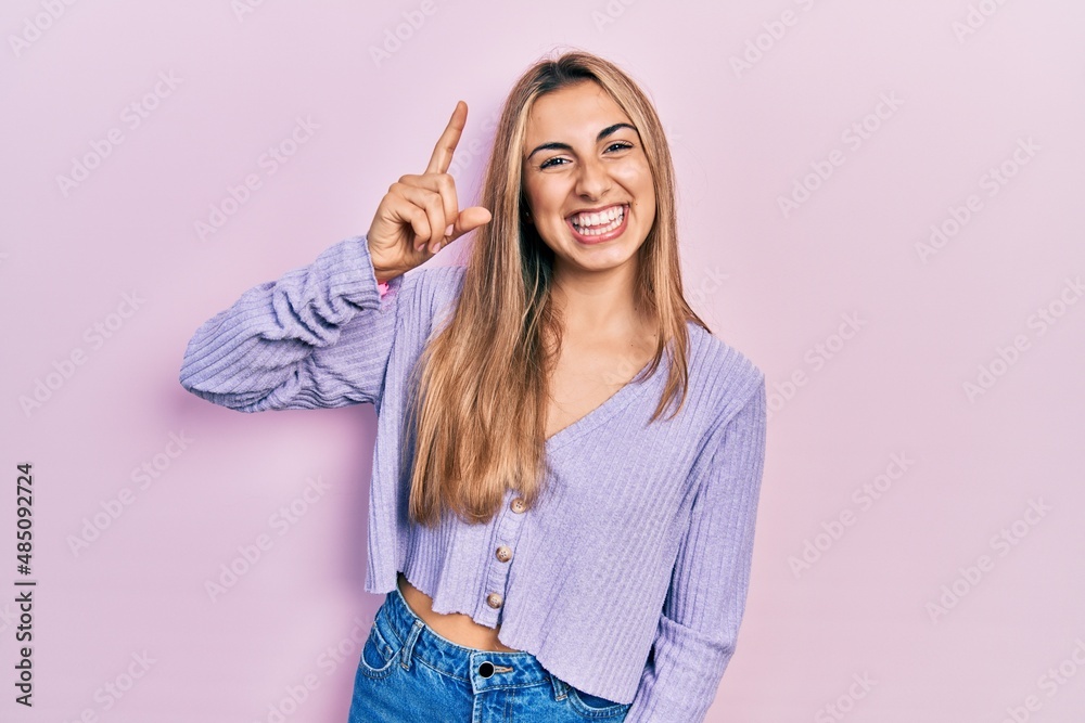 Canvas Prints Beautiful hispanic woman wearing casual shirt pointing finger up with successful idea. exited and happy. number one.