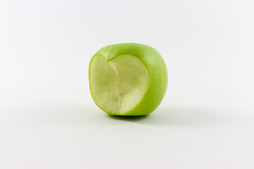 Fresh Green apple with  heart symbol bite isolated on white background
