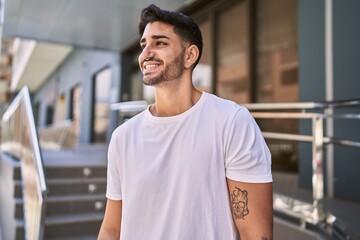 Handsome hispanic man smiling happy outdoors