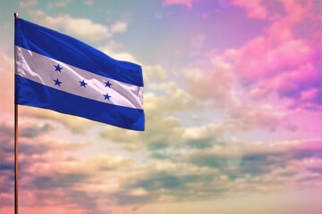 Fluttering Honduras flag mockup with the space for your content on colorful cloudy sky background. - obrazy, fototapety, plakaty