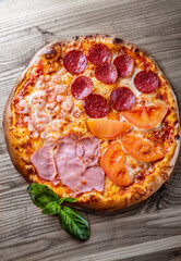 pizza with Mozzarella cheese, ham, shrimp, salami. Italian pizza on wooden table background