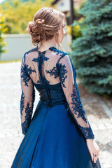Back view of a girl in glamorous ultramarine dress. Ready for her prom night. © stivog