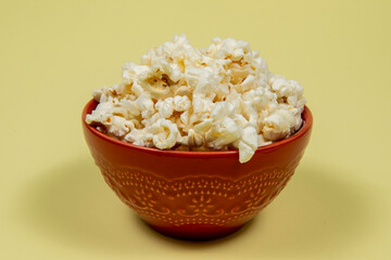 A ceramic bowl of salted popcorn