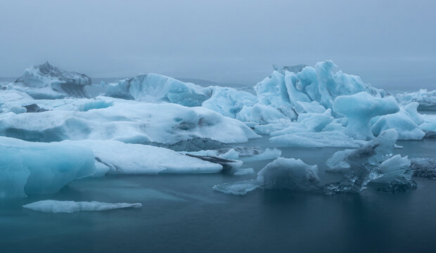Icebergs on cloudy and dark day