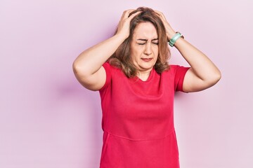 Middle age caucasian woman wearing casual clothes suffering from headache desperate and stressed because pain and migraine. hands on head.