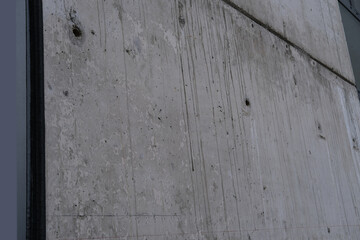 concrete gray wall of an architectural building, building material, texture for a designer