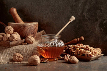 Honey and walnuts on a kitchen table.