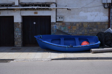Blue boat with a buoy in the harbor