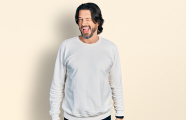 Middle age caucasian man wearing casual clothes winking looking at the camera with sexy expression,...