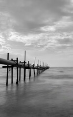pipelines strectching to the sea in black and white