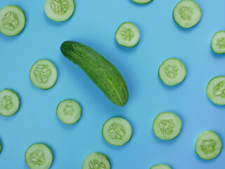 background from cucumbers on blue. Healthy food concept