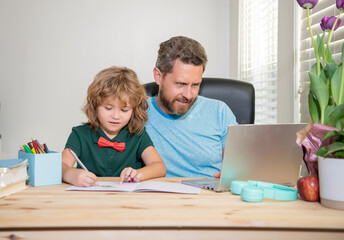 Fototapeta premium bearded dad or school private tutor teaching boy son with modern laptop, lesson online