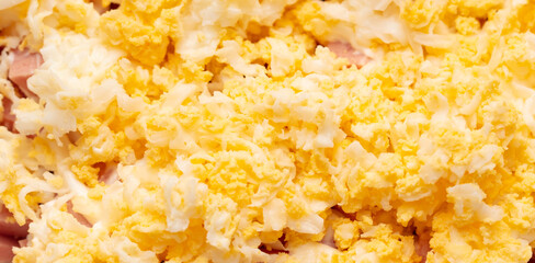 Egg yolks in a salad as a background.