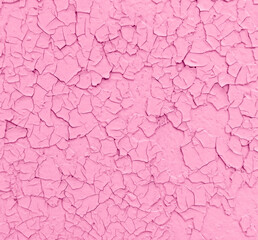 Cracked pink paint on the wall as an abstract background.