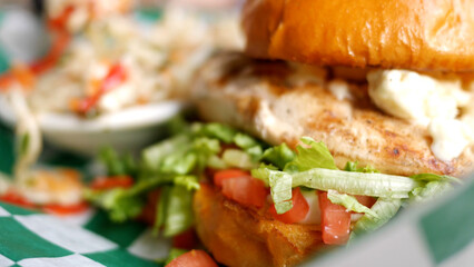 A Grilled Chicken Sandwich with Lettuce and Tomato