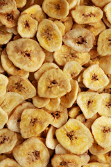 Homemade Banana Chips background, top view.