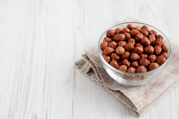 Unshelled Hazelnut in a Bowl, low angle view. Copy space.