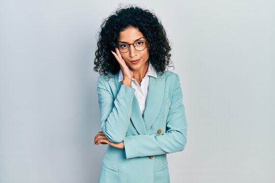Young latin girl wearing business clothes and glasses thinking looking tired and bored with depression problems with crossed arms.