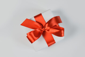 Christmas or any holidays mock up Gift box wrapped in paper and with red bow isolated on white background