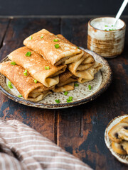 Rolled pancakes with green onion and mushroom close up