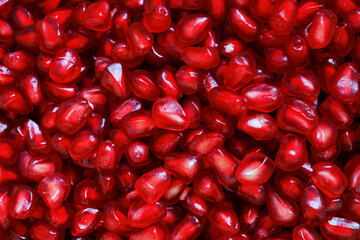 Red Background of Grain Red Grenades. Big Ripe Red Granets or Garnets. Fruits of Red Ripe Pomegranate. Vegetarian Concept, Organic Vitamins. Organic and Benefit Garnet Fruit.