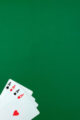 Casino gambling poker blackjack cards on green desk background. Concept of winning hand in poker game with aces. 