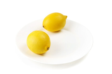 Two beautiful lemon are on white plate 