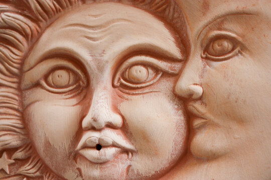 terracotta sun and moon faces, Orvieto, Italy 