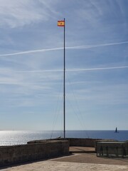 Spanish flag over Castillo San Carlos, Palma, Mallorca, Balearic Islands, Spain