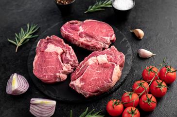 raw beef steaks on stone background