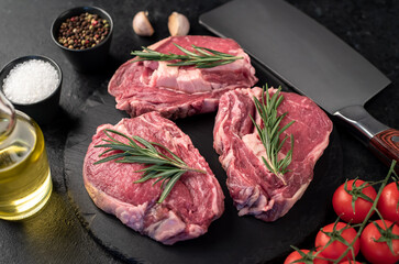 raw beef steaks on stone background