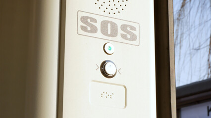 SOS signal button inside the tram, train, emergency help system push button, Braille inscription, detail, closeup Public transport safety, urban transportation security, accessibility abstract concept