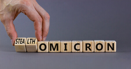 Covid-19 stealth omicron symbol. Doctor turns cubes and changes words omicron to stealth omicron....