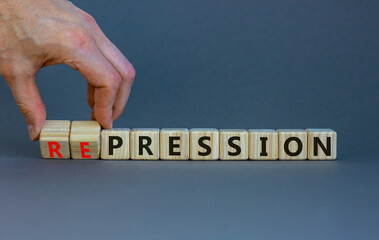 Pression to repression symbol. Businessman turns wooden cubes, changes the word pression to...