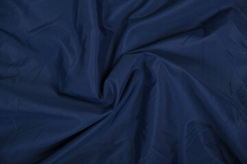 Blue fabric texture, background. folds close up. classic blue pantone
