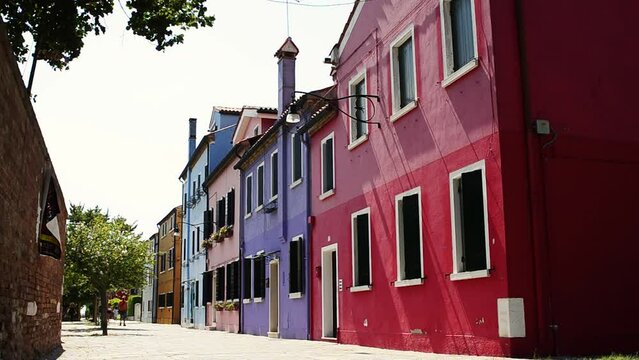 Venice Lagoon, Island of Burano. Italy, August 2018. In the secondary streets, away from the channels that cross Burano, we find silent and colorful paradisiac glimpses from the typical houses.