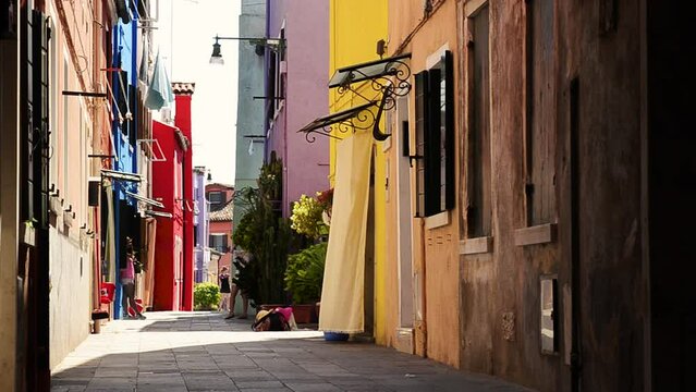 Venice Lagoon, Island of Burano. Italy, August 2018. In the secondary streets, away from the channels that cross Burano, we find silent and colorful paradisiac glimpses from the typical houses.