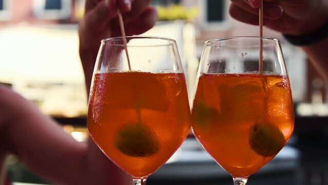Venice, Veneto Region, Italy. August 2018. Savoring a spritz in Venice is a must if you visit the city. Towards late afternoon the bars are colored with full glasses of tasty and refreshing aperitifs.