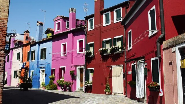 Venice Lagoon, Island of Burano. Italy, August 2018. In the secondary streets, away from the channels that cross Burano, we find silent and colorful paradisiac glimpses from the typical houses.