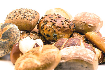close up view of a bunch of healthy fresh baked diffrent buns and rolls from an bakery shop
