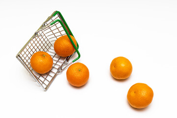 fresh tangerines fell out of a miniature grocery basket