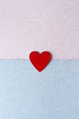 red heart on pink and blue parchment-like paper texture