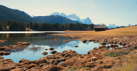 idyllic moor lake Geroldsee, view to Wetterstein mountains and hay hut, bavarian landscape
