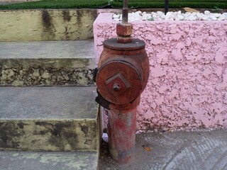 Fototapeta na wymiar old red fire hydrant water pump