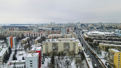 Aerial view of houses and road in the large city. Winter landscape. Residential areas in central of Minsk in the snow.