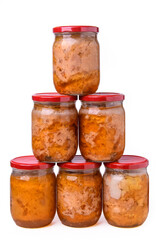 Six glass jars with canned stew built into a pyramid. Canned meat