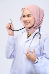 Female muslim doctor with hijab over white background studio.