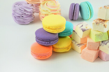 Macaroons, marshmallows and zephyrs. Traditional colored sweet desserts for the holiday, copy space.
