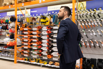 manager in a hardware store inspects retail space